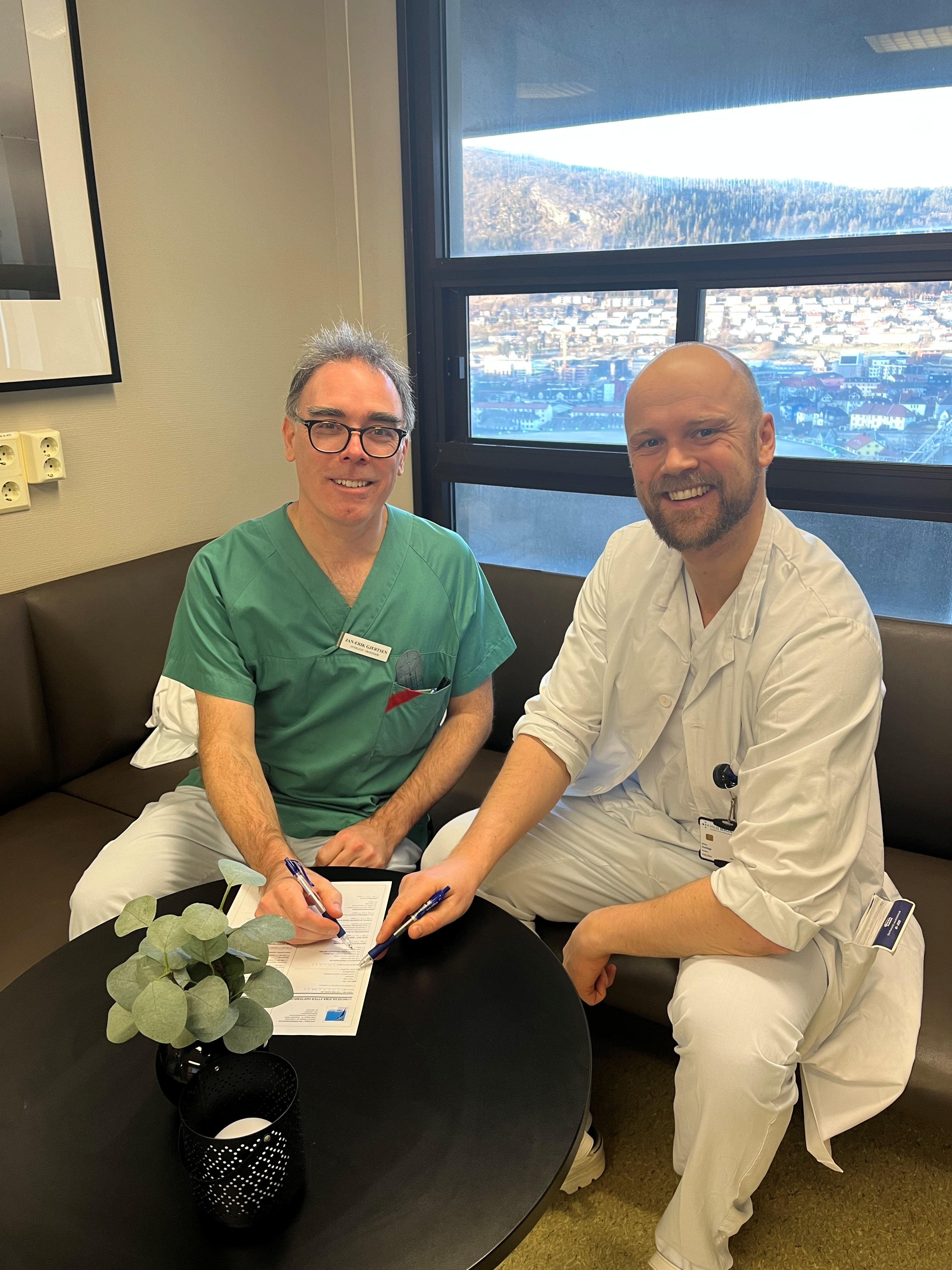 To menn som sitter i en sofa