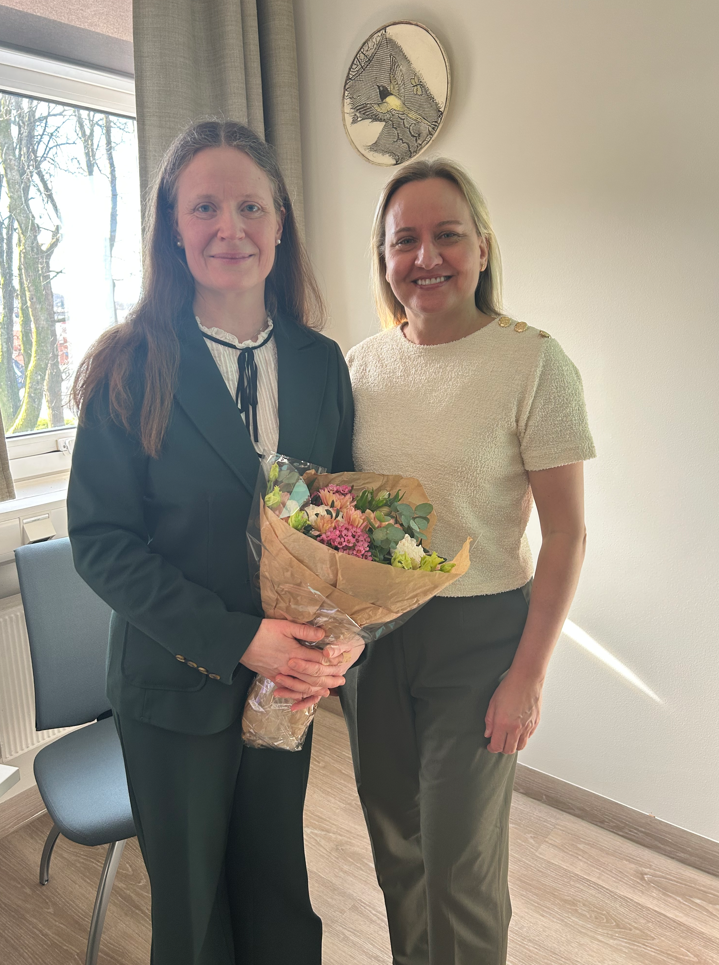 Et par kvinner som holder blomster