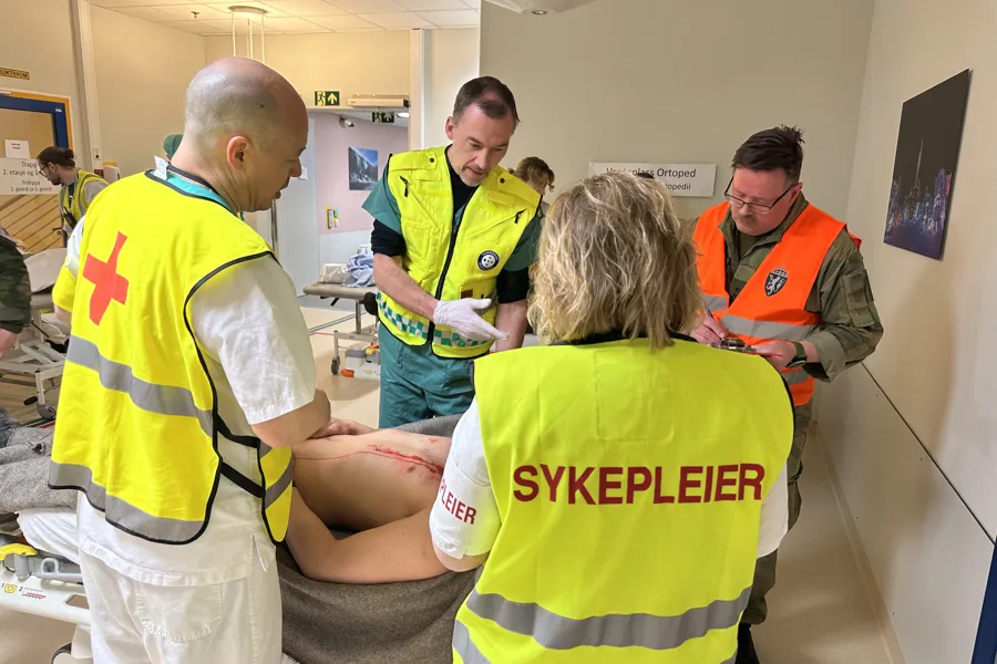 En gruppe mennesker i sikkerhetsvester i et rom