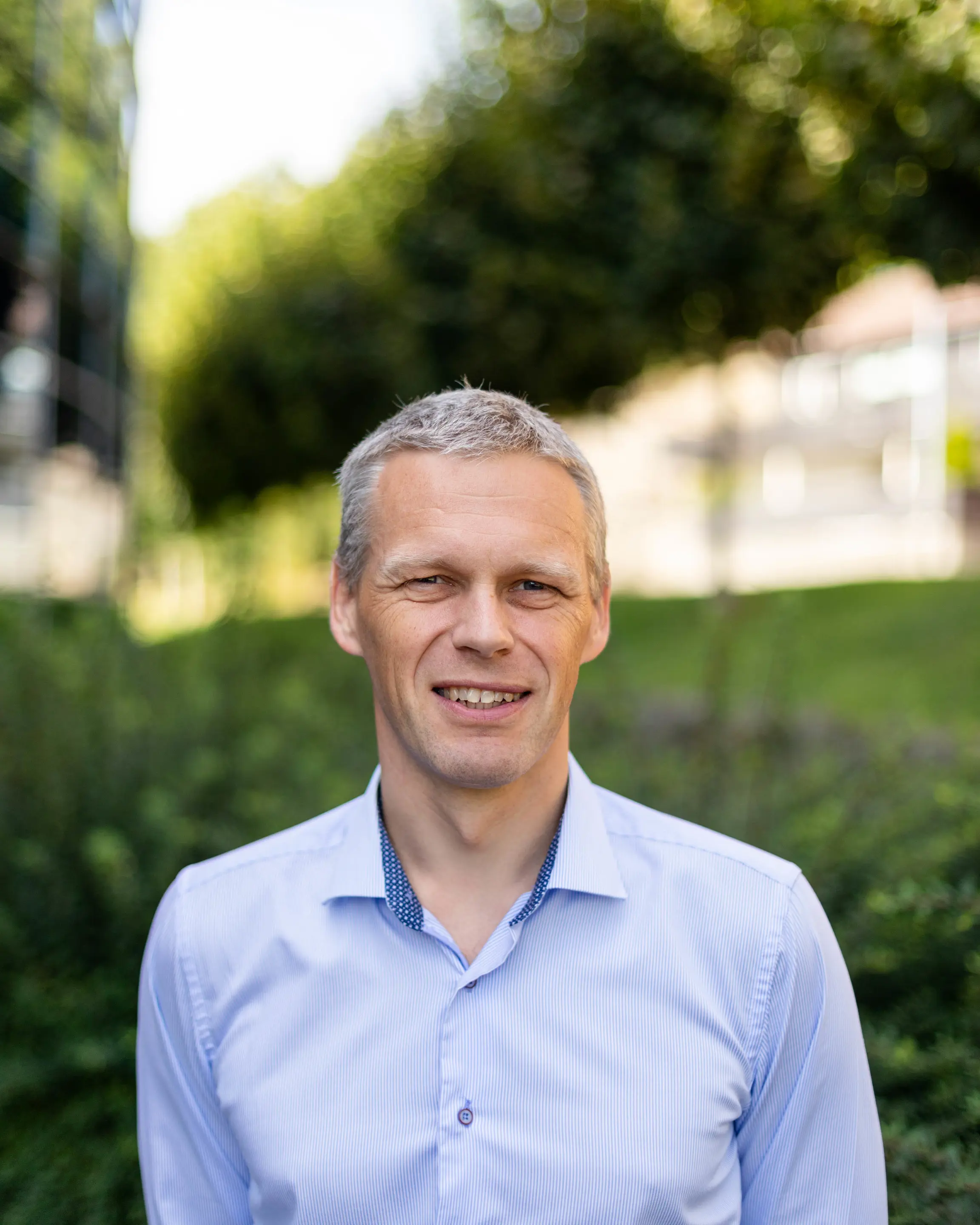 En mann som smiler til kameraet