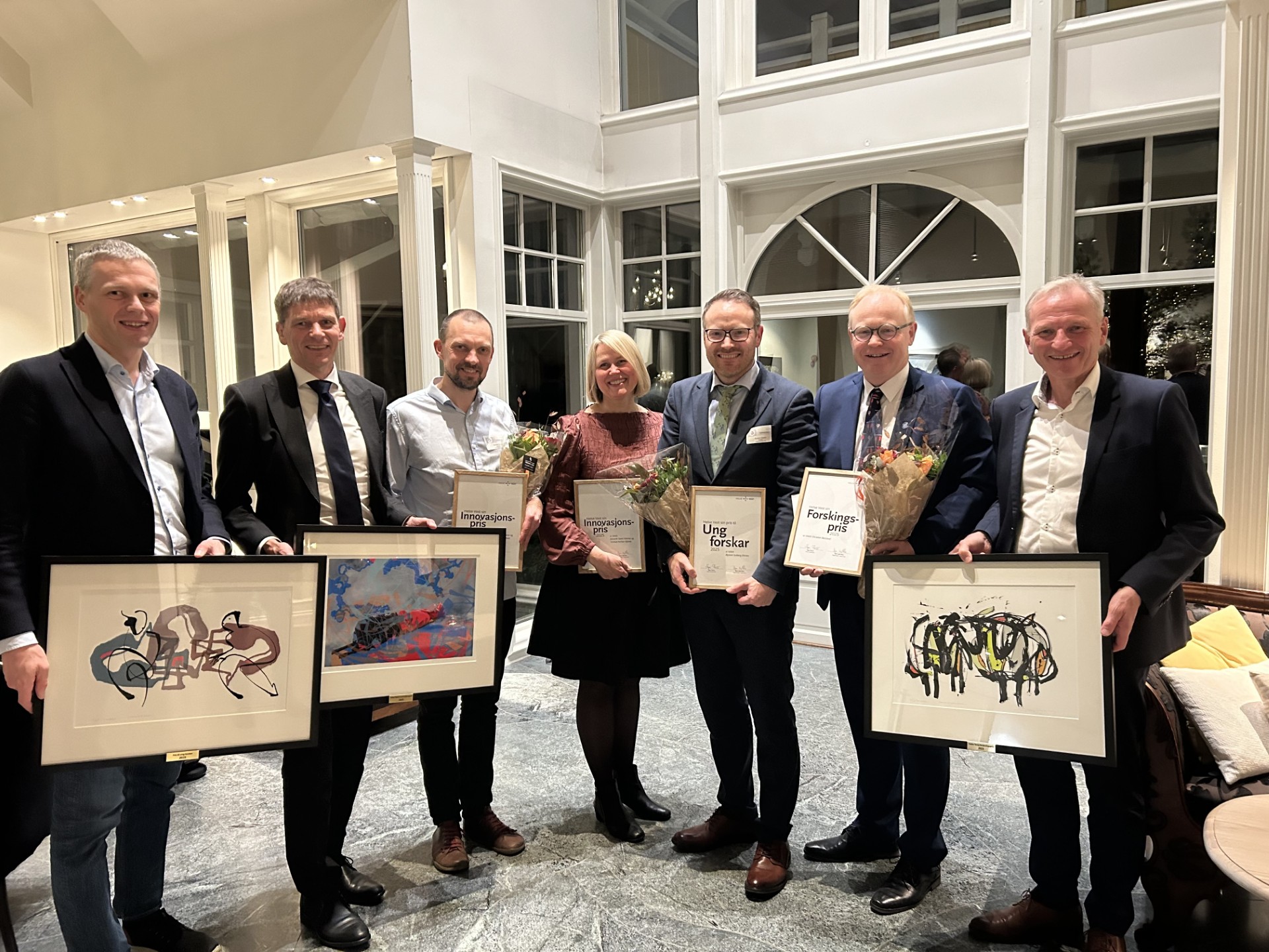 A group of people holding certificates